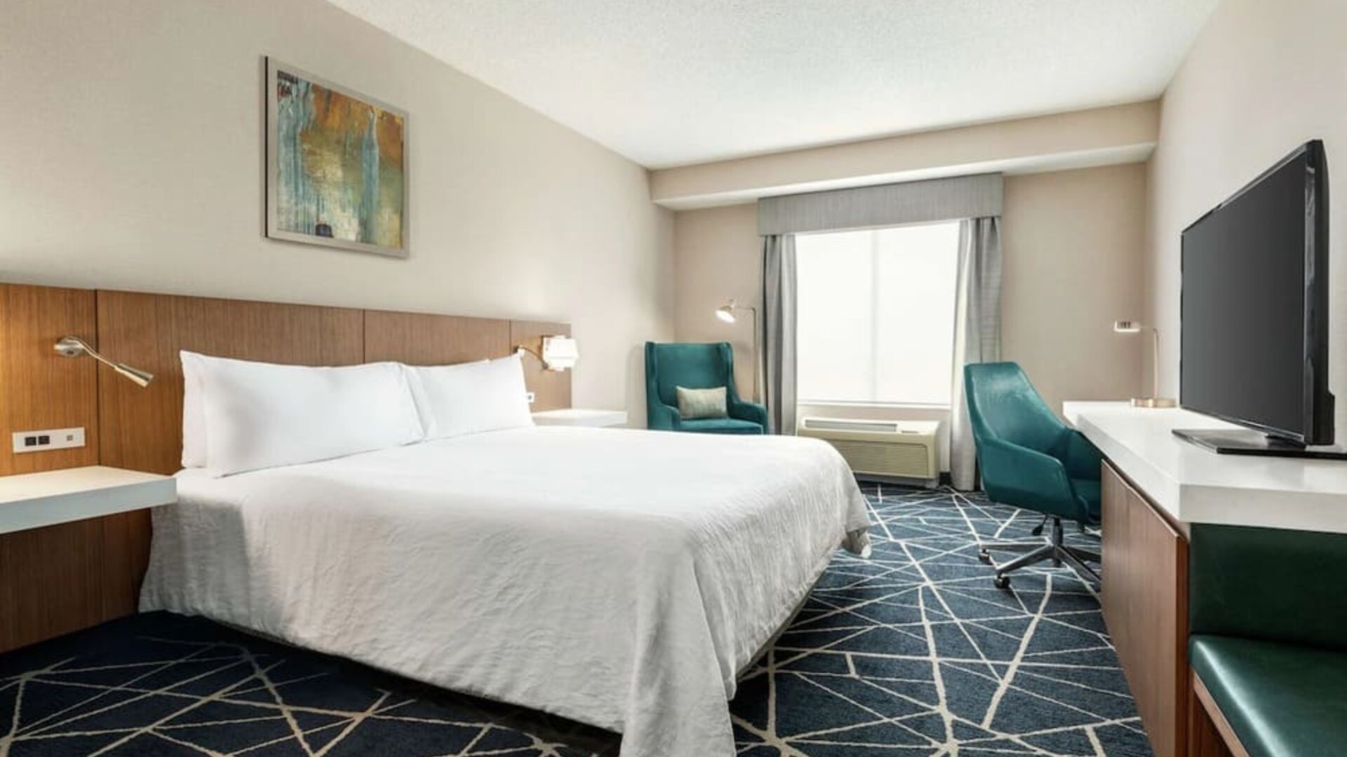 Day use room with TV, work desk and sofa at the Hilton Garden Inn Kitchener/Cambridge.