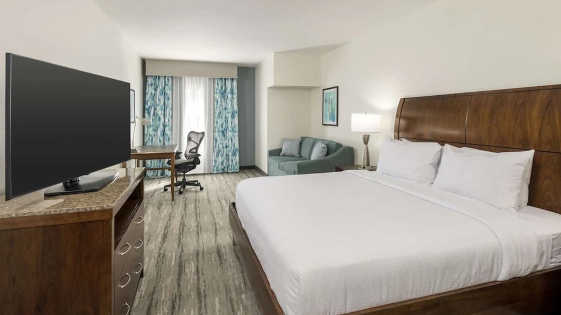 Day use room with work desk and sofa at Hilton Garden Inn Boca Raton.