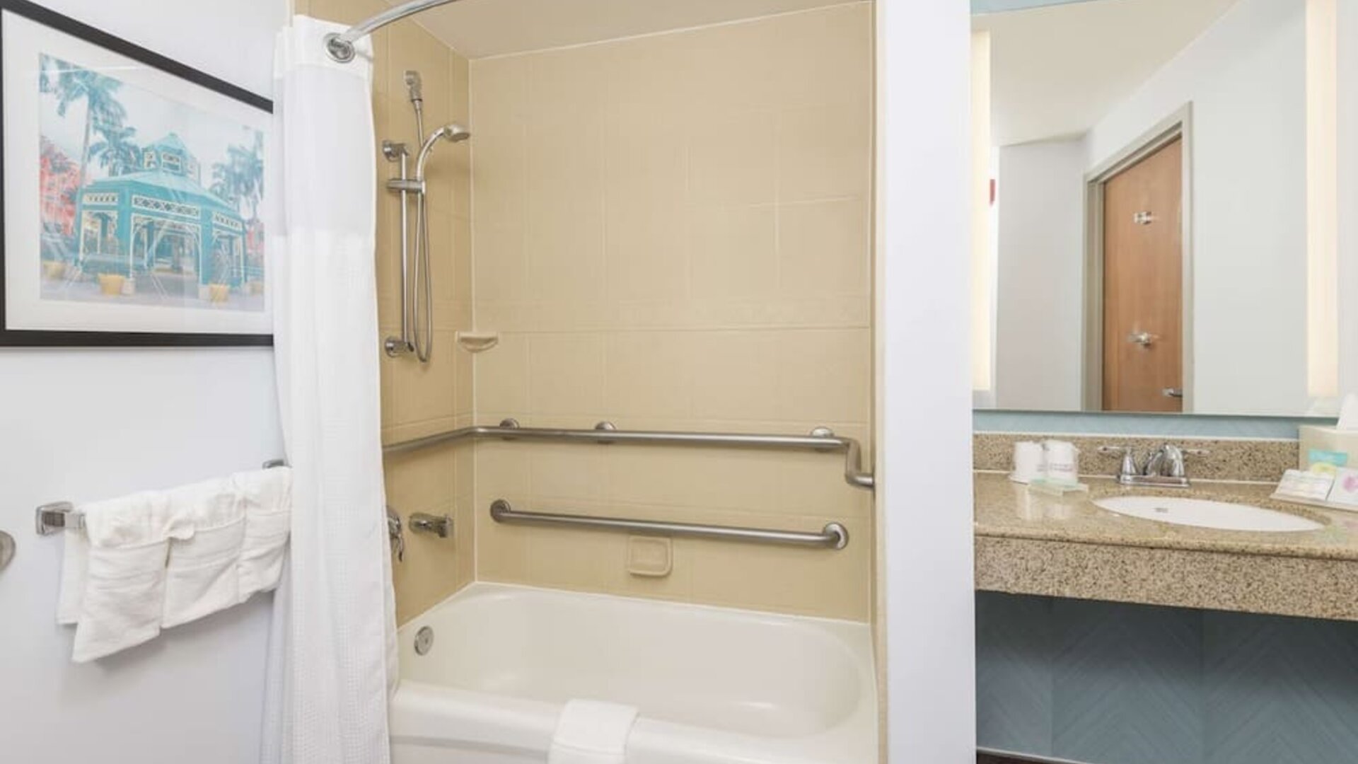 Guest bathroom with shower and tub at Hilton Garden Inn Boca Raton.