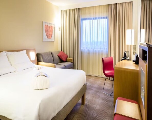 Day use room with work desk and sofa at Novotel London Paddington.
