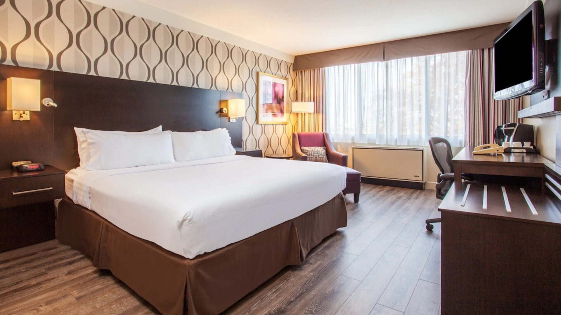 Day use room with TV, sofa, work desk and private bathroom at Holiday Inn Toronto International Airport. 