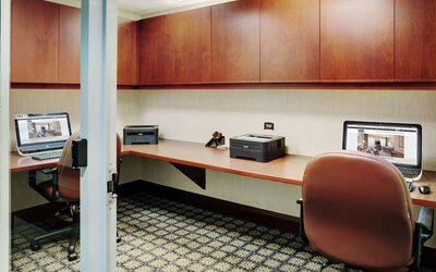 Business center with computers, printers and ergonomic chairs at Staybridge Suites Oakville-Burlington.