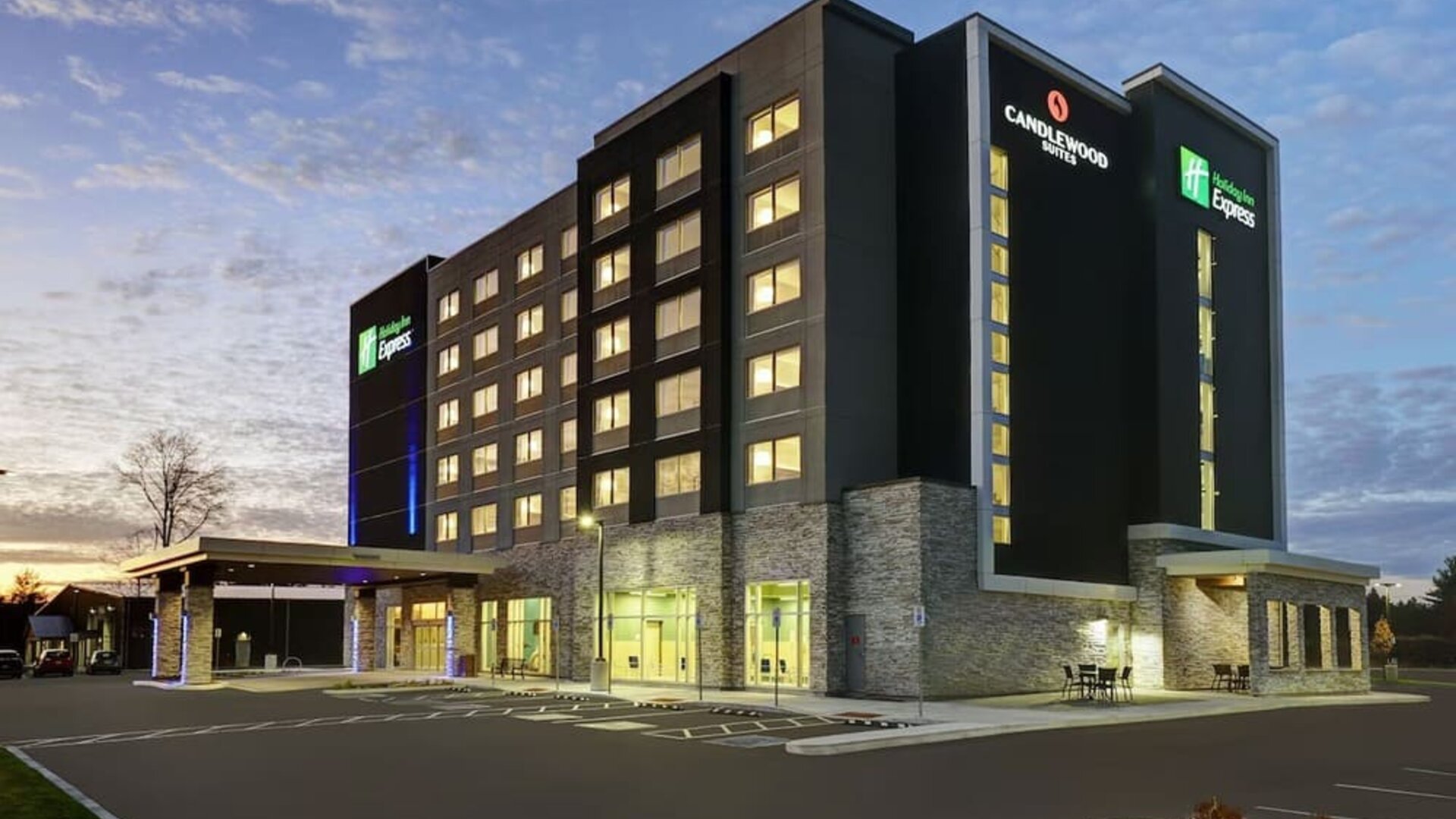 Hotel exterior and parking area at Holiday Inn Express Kingston West.