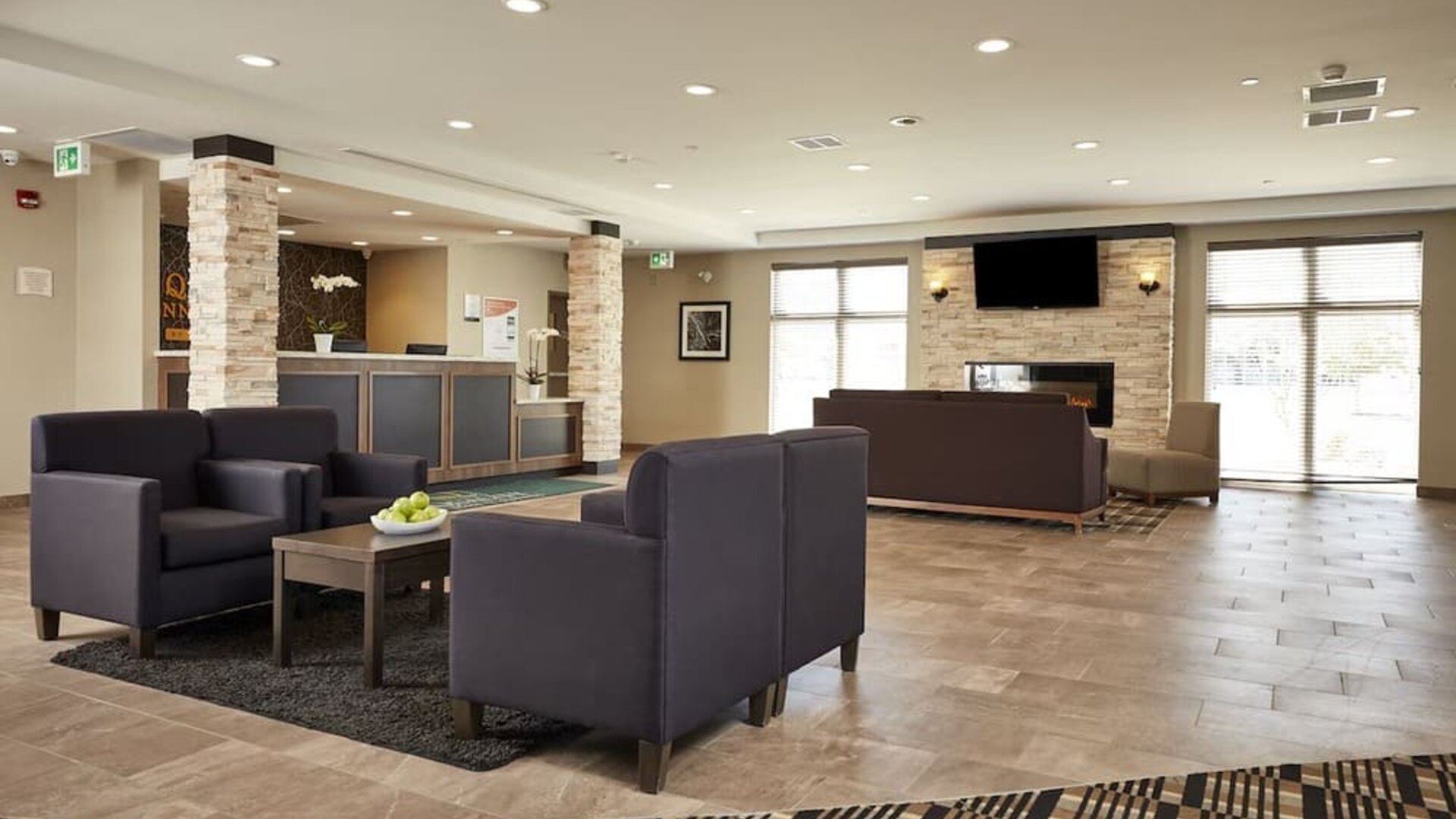 Hotel lobby with lounge area at Quality Inn & Suites Kingston.
