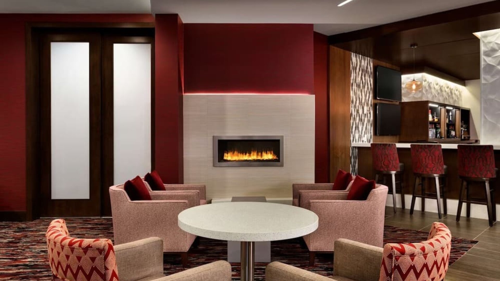 Hotel bar comfortable lounge area with fireplace at DoubleTree By Hilton Hotel Toronto Airport West.