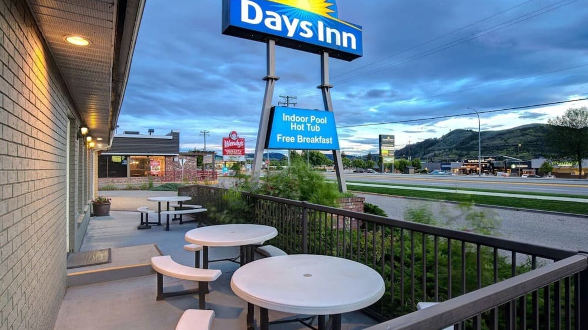 Hotel exterior with sitting area at Days Inn Vernon.