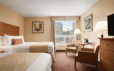 Day use twin room with TV, sofas, large window and private bathroom at Days Inn Edmonton Downtown.