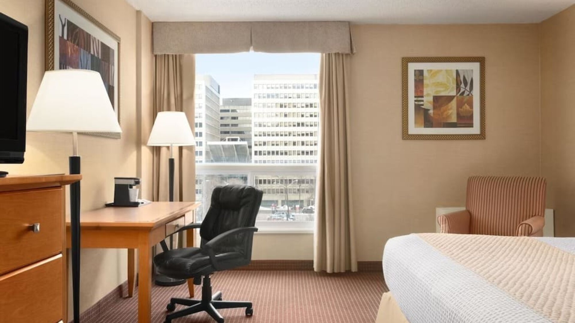 Bright and spacious day use room with TV, sofa, work desk and private bathroom at Days Inn Edmonton Downtown.
