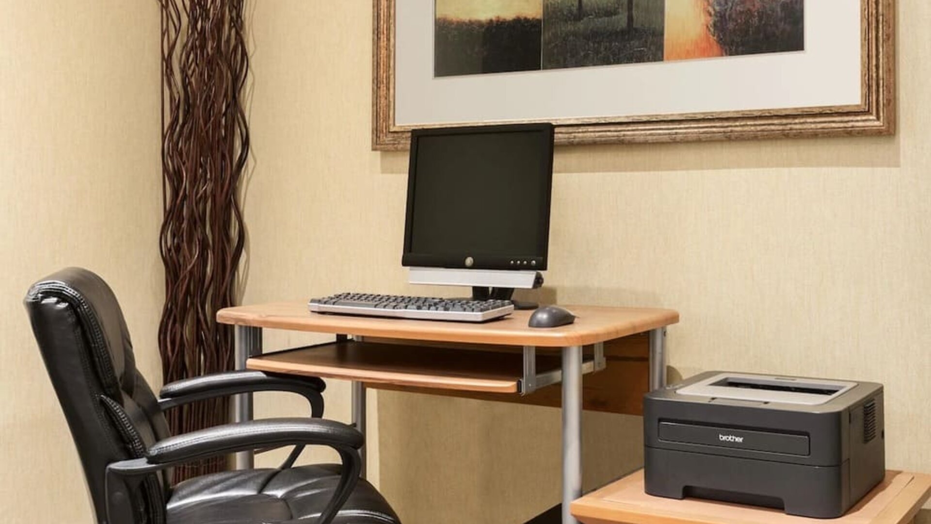 Business center with computer, printer and ergonomic chair at Days Inn Edmonton Downtown.