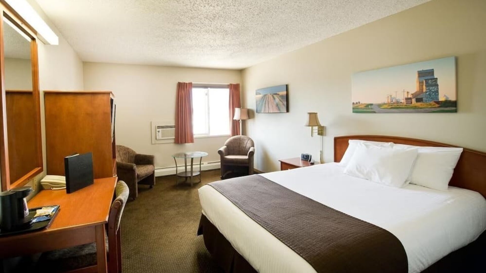 Day use room with living area, work desk and private bathroom at Riviera Motor Inn.