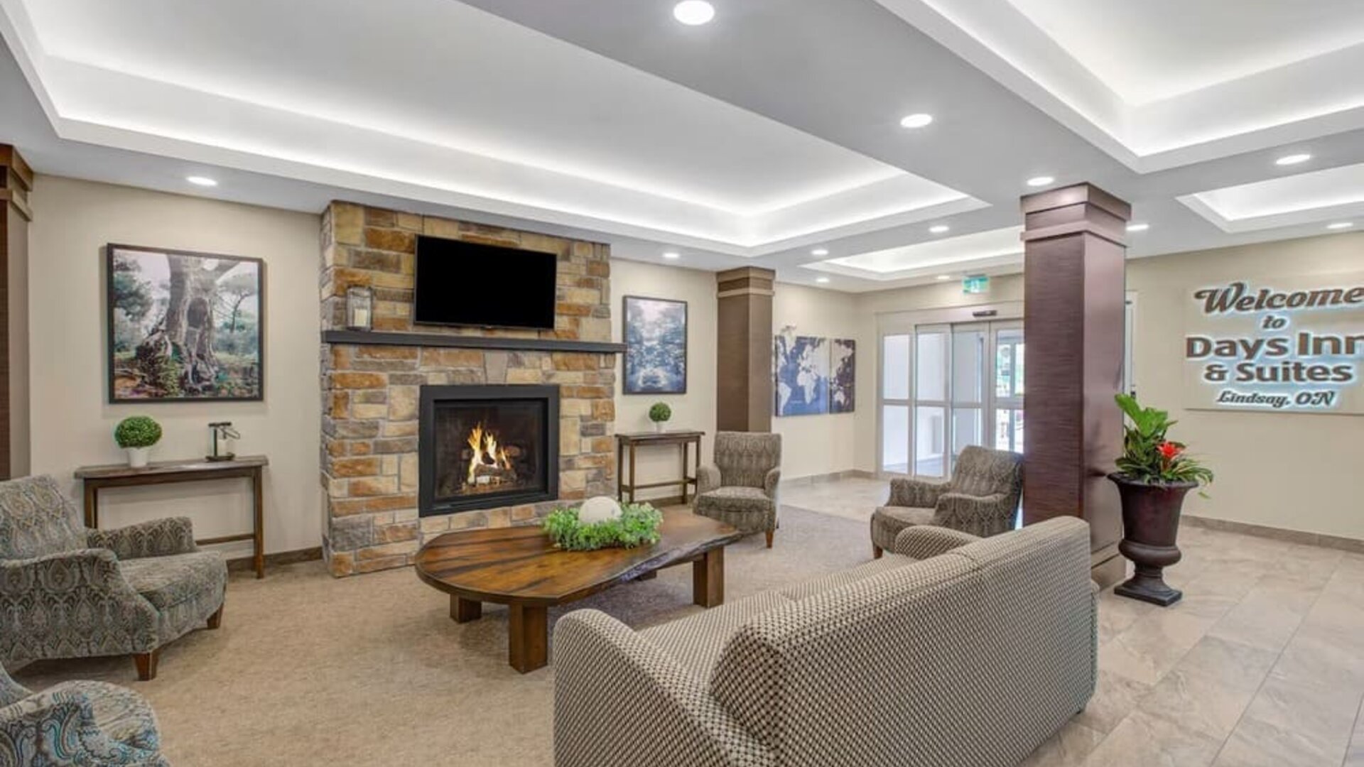 Lobby lounge area with fireplace at Days Inn & Suites By Wyndham Lindsay.