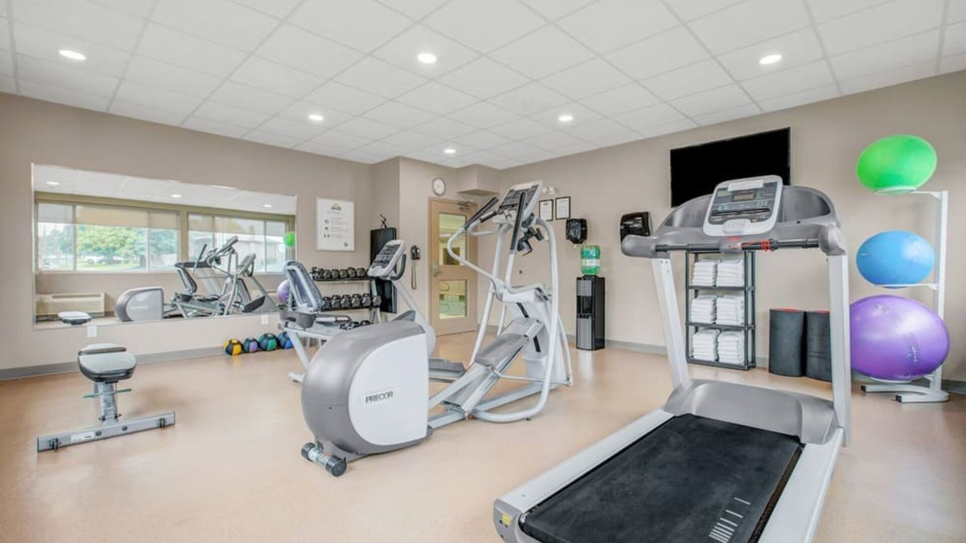 Fully equipped fitness center at Days Inn & Suites By Wyndham Lindsay.