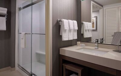 Private guest bathroom with shower and free toiletries at Courtyard By Marriott Toronto Airport.