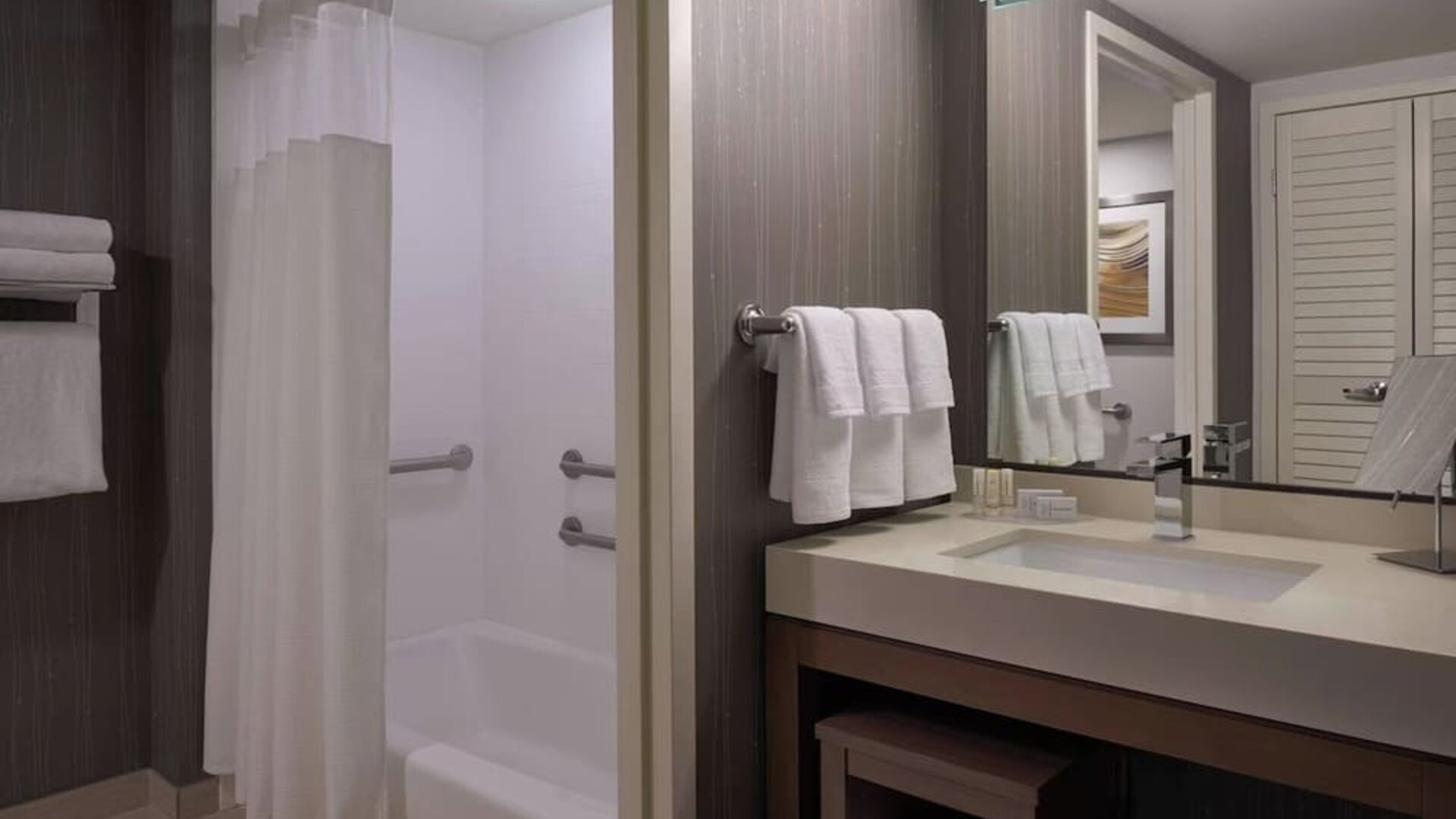 Private guest bathroom with tub and free toiletries at Courtyard By Marriott Toronto Airport.