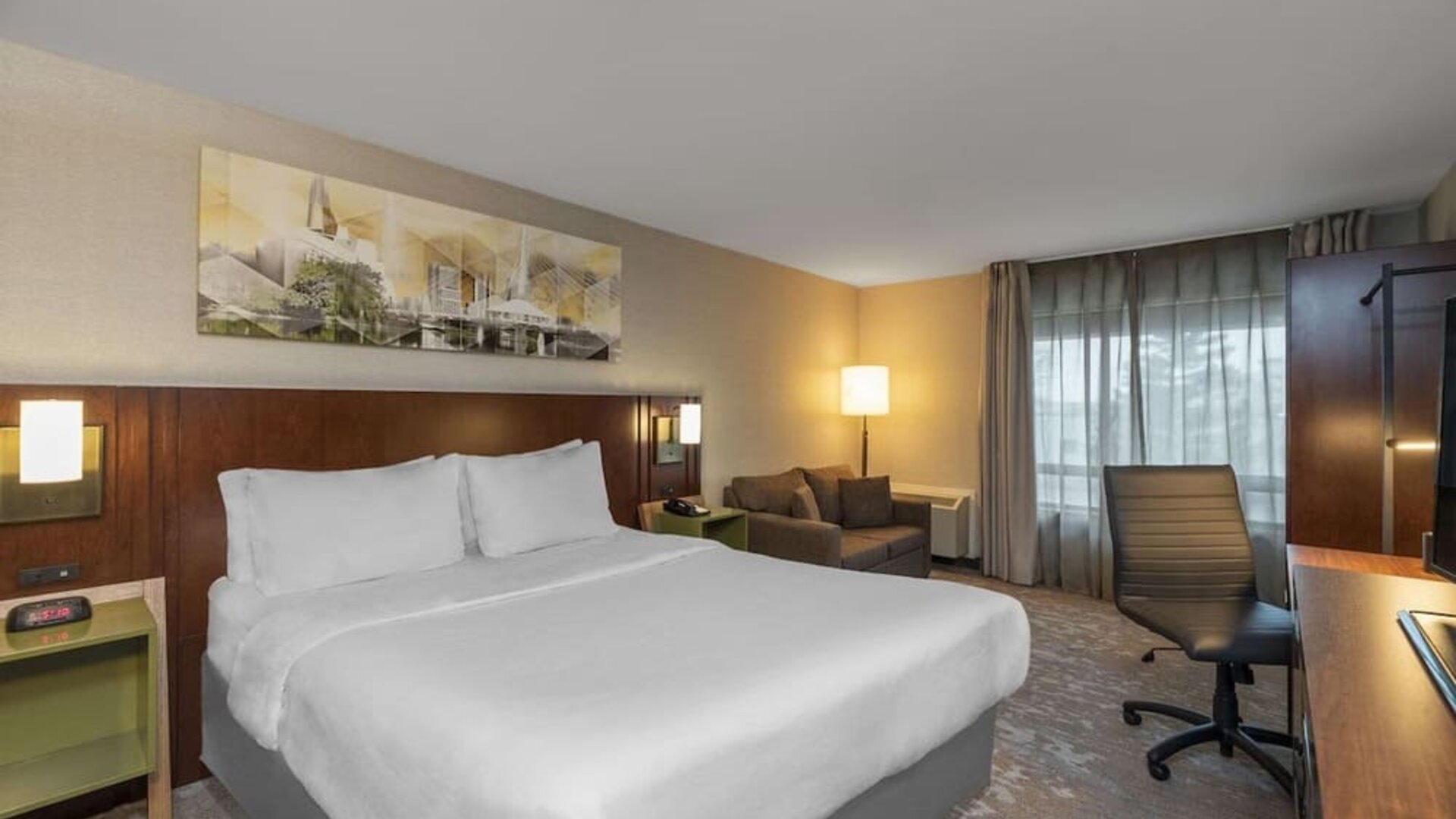 Day use room with TV, sofa, work desk and private bathroom at Comfort Inn Sudbury Regent Street.