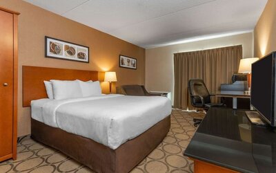Standard day use room with TV, work desk, sofa and private bathroom at Comfort Inn Simcoe.