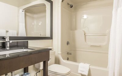 Guest bathroom with tub and free toiletries at Comfort Inn Sept-Iles. 