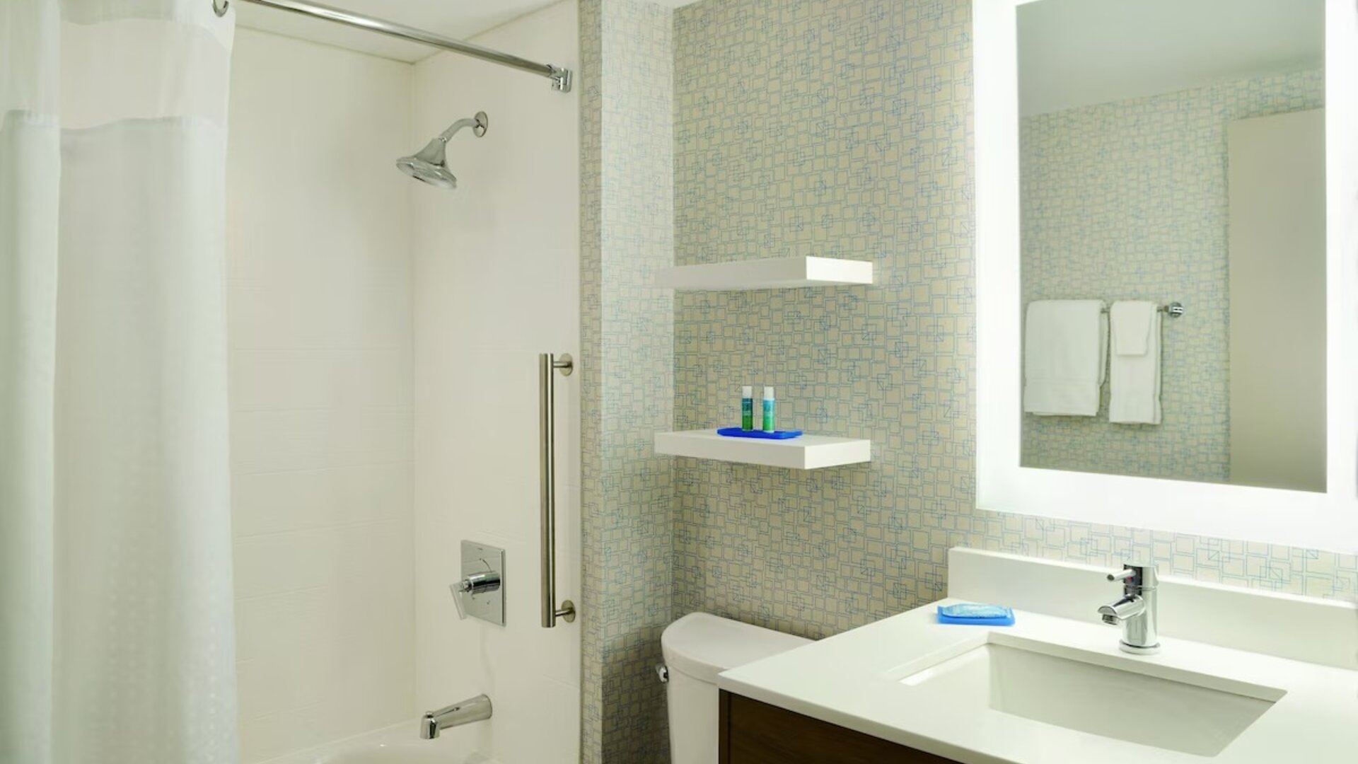 Private guest bathroom with shower and tub at Holiday Inn Express Toronto Downtown.