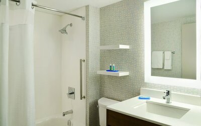 Private guest bathroom with shower and tub at Holiday Inn Express Toronto Downtown.