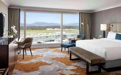 Bright and spacious day use room with TV, sofa, work desk and private bathroom at Fairmont Vancouver Airport - YVR Terminal Hotel.