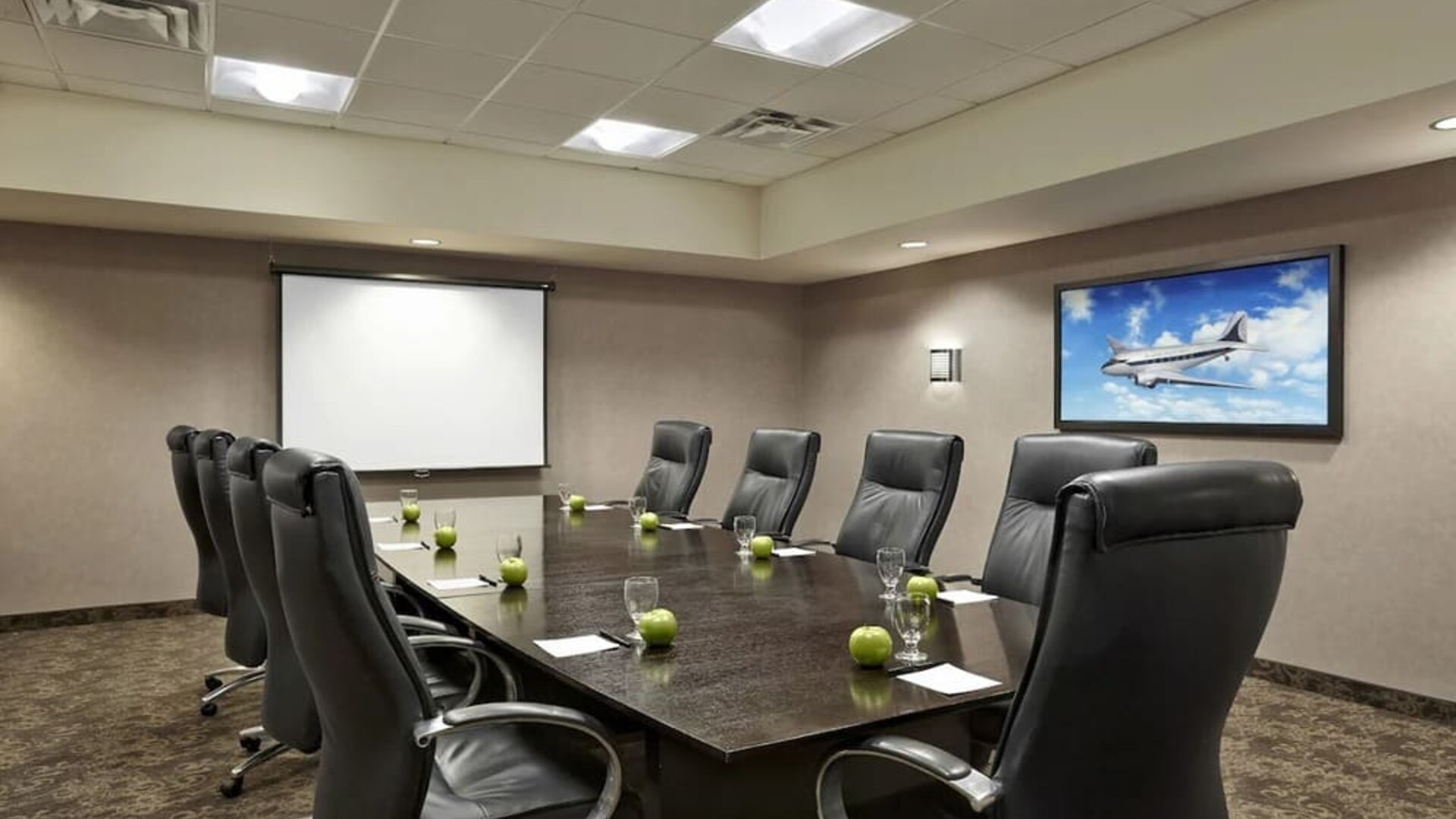 Professional meeting room with ergonomic chairs at Acclaim Hotel Calgary Airport.