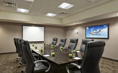 Professional meeting room with ergonomic chairs at Acclaim Hotel Calgary Airport.