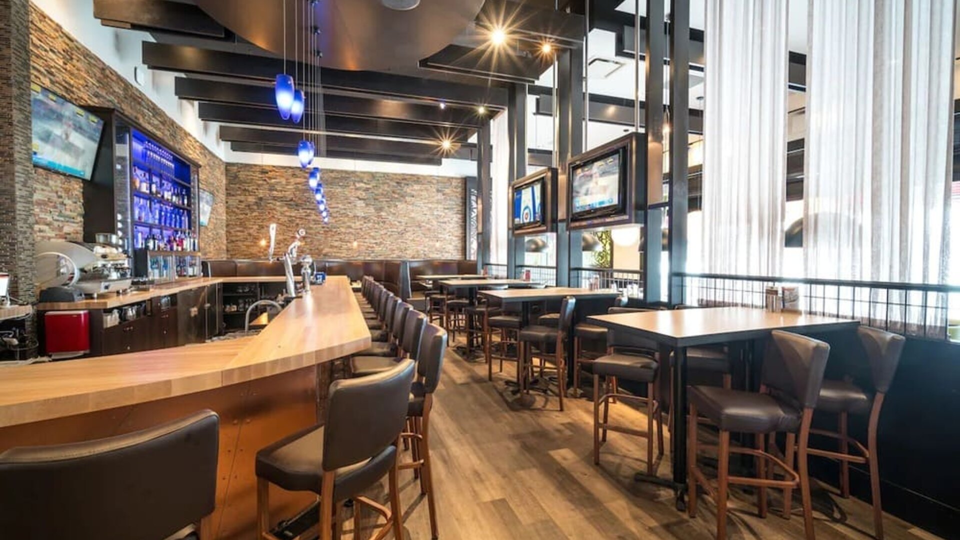 Hotel bar with lounge seating at Acclaim Hotel Calgary Airport.