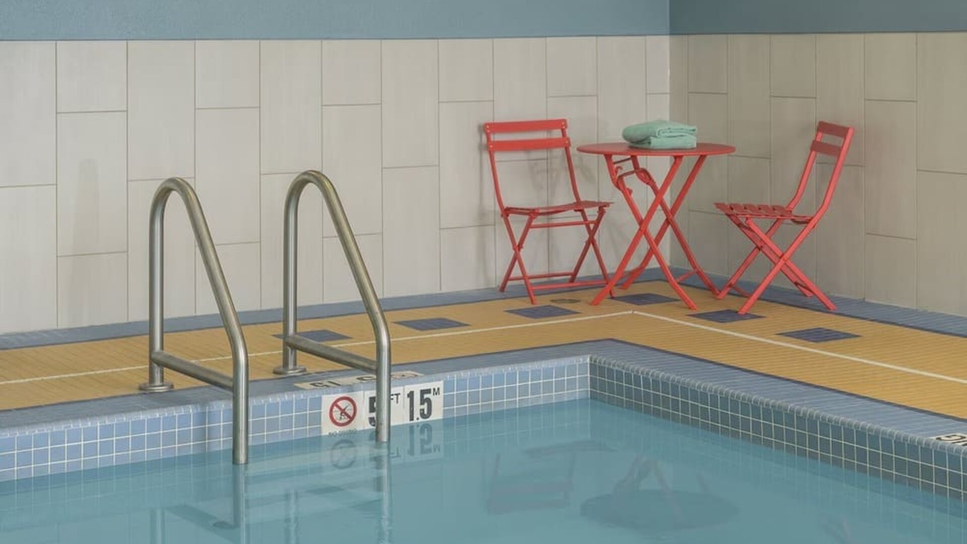 Indoor pool with seating at Holiday Inn Express & Suites North Bay.