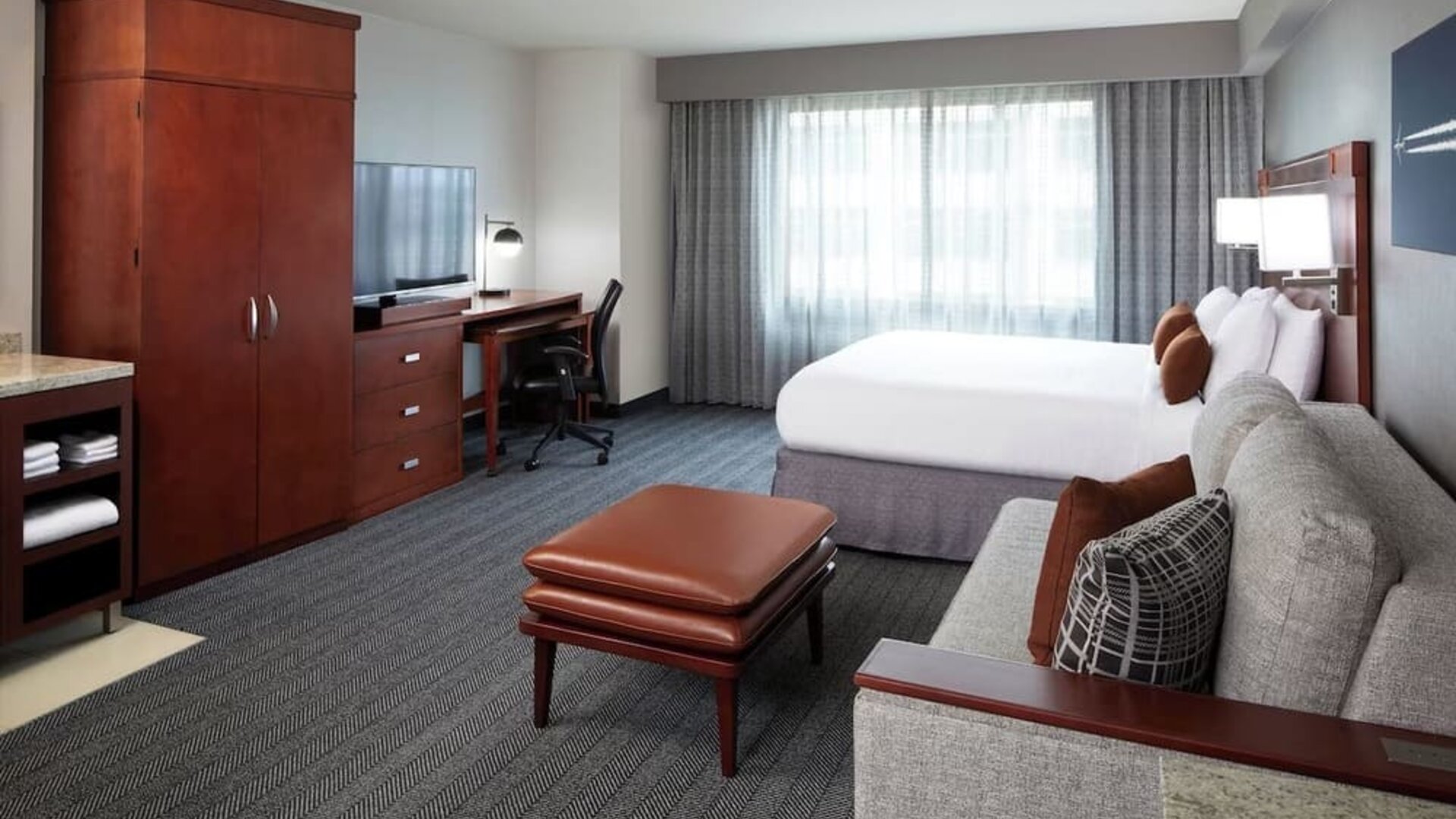 Day use room with sofa and work desk at Courtyard By Marriott Los Angeles LAX/Century Boulevard.