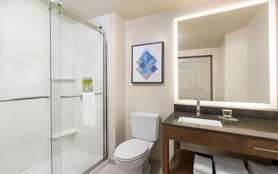 Guest bathroom with shower at Candlewood Suites Meridian.