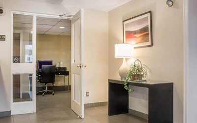 Business center with computer, printer and ergonomic chair at Comfort Inn Winnipeg II South.