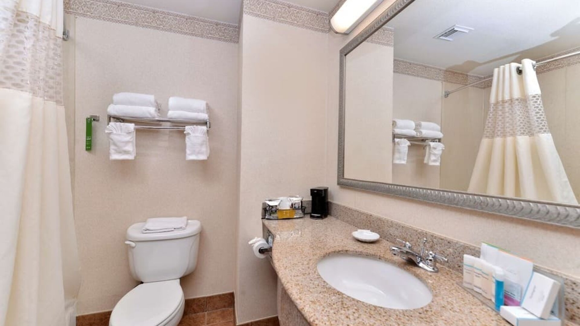 Guest bathroom with shower at Hampton Inn Deer Park.