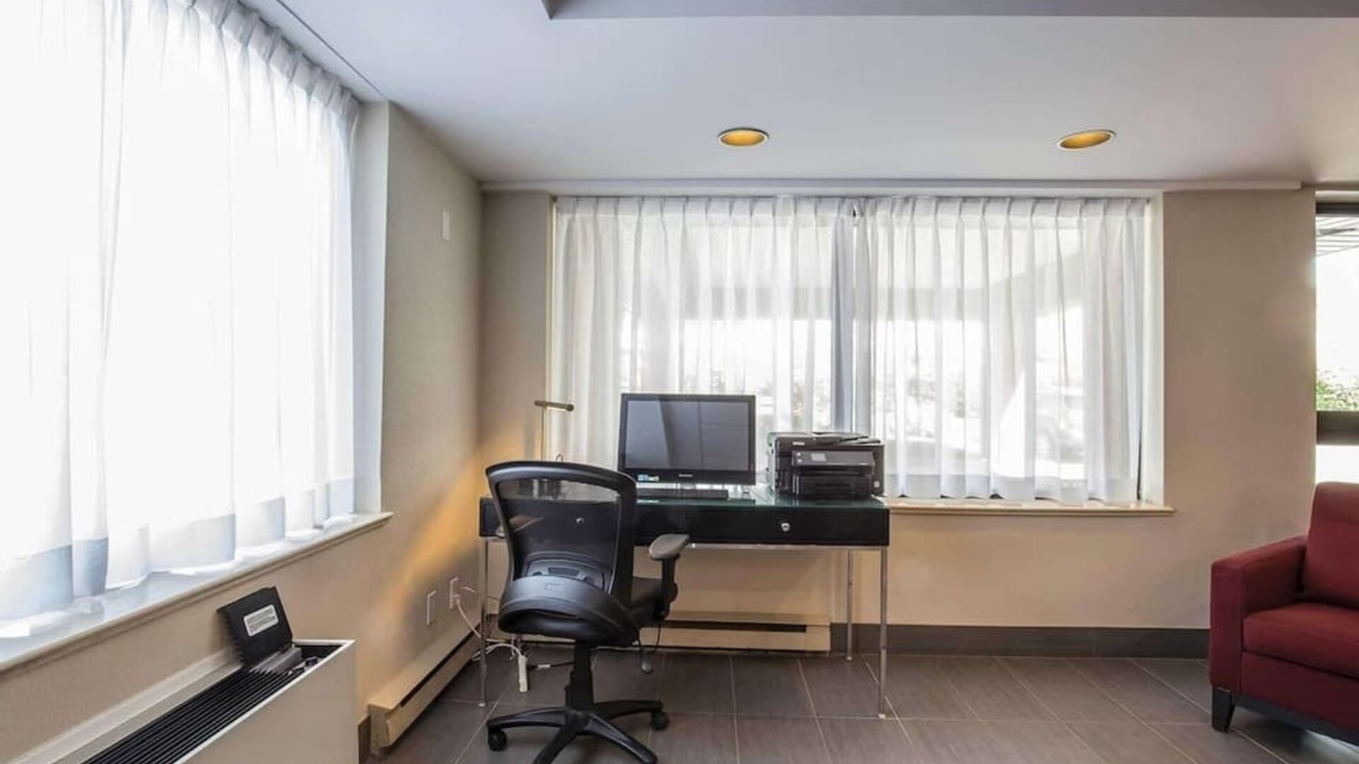 Business center with computer, printer and ergonomic chair at Comfort Inn Pickering.