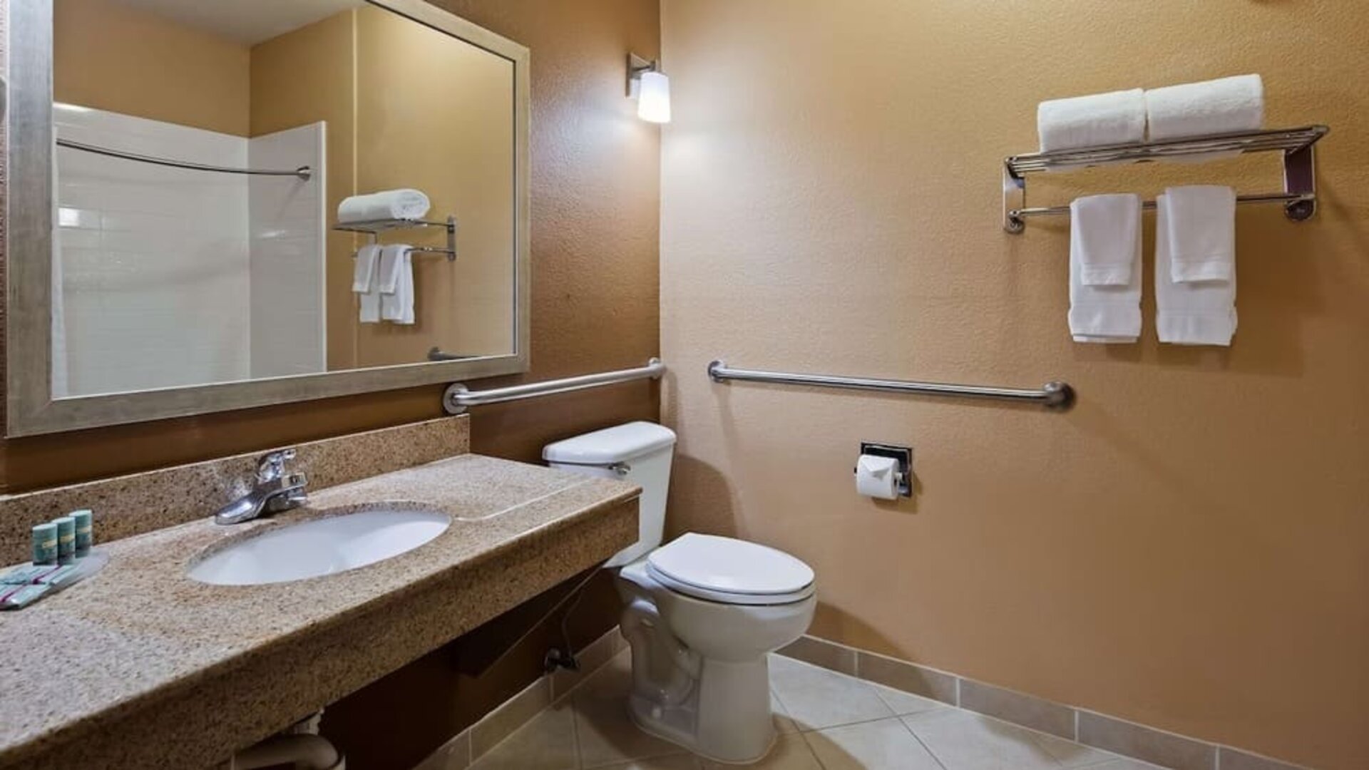 Guest bathroom with shower at Best Western Granbury Inn & Suites.