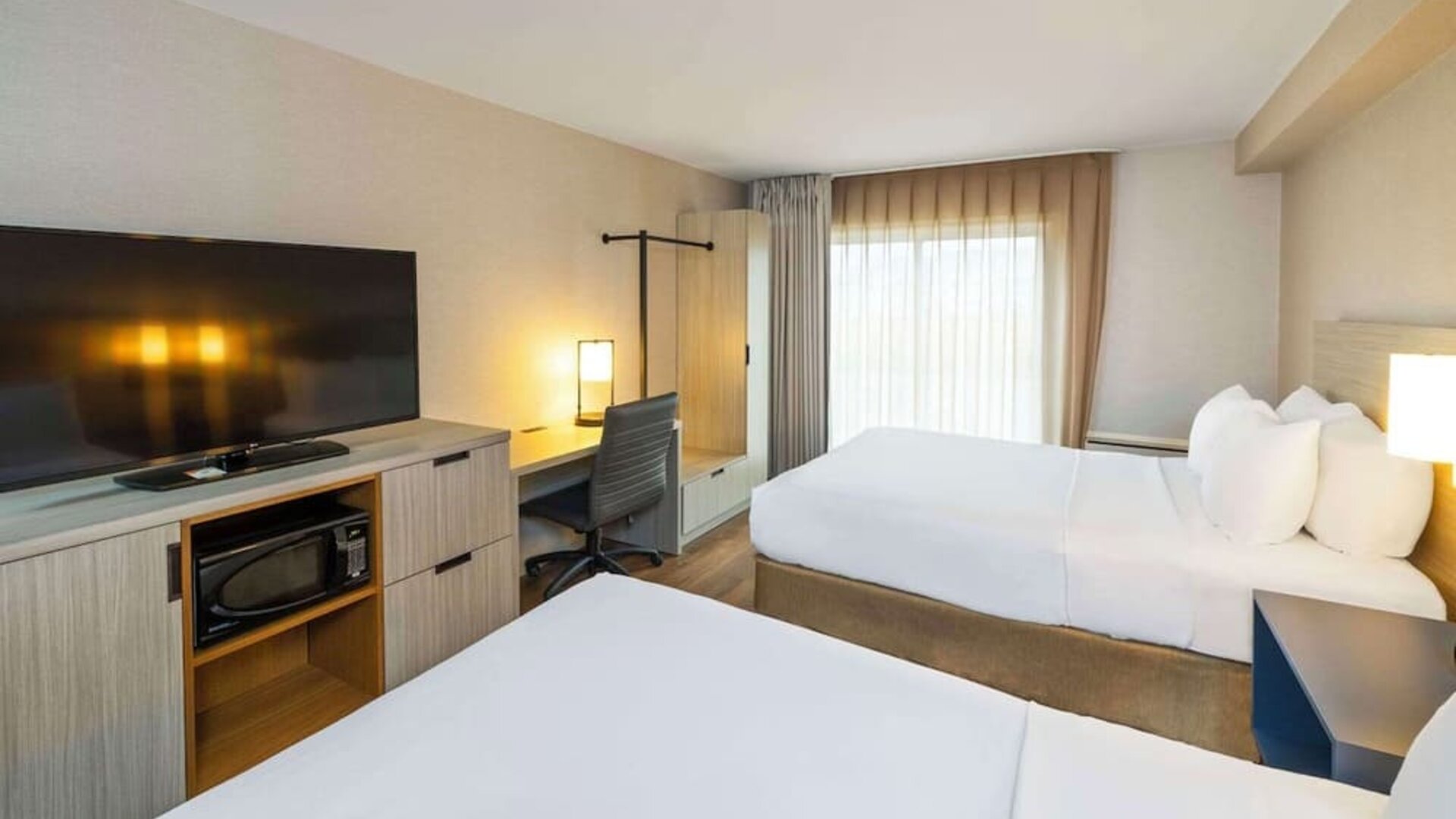 Day use twin room with TV and work desk at Comfort Inn Amherst.