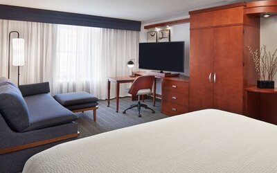 Bright and spacious day use room with TV, work desk, sofa and private bathroom at Courtyard By Marriott Waterloo St. Jacobs.