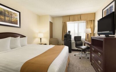 Bright day use room with TV, work desk and sofa at Travelodge Edmonton South.