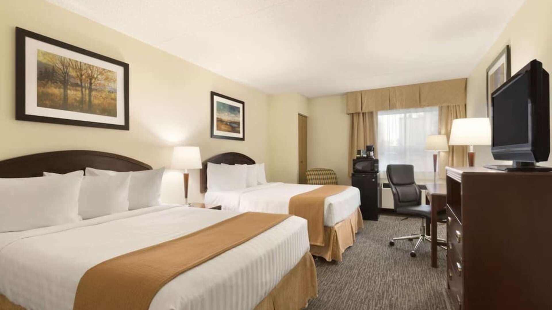 Bright and spacious day use room with TV, work desk and private bathroom at Travelodge Edmonton South.