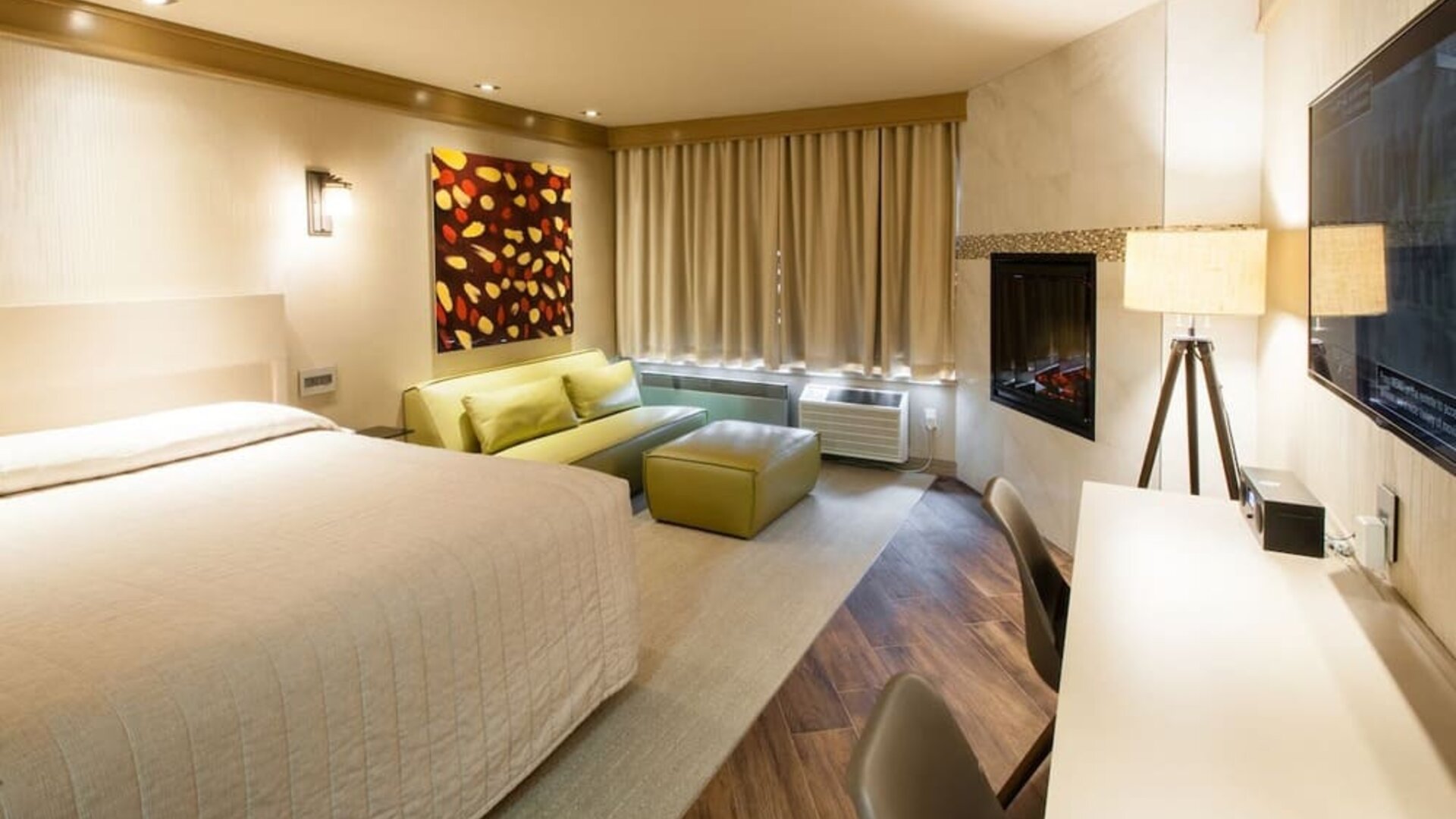 Day use room with TV, work desk, fireplace and private bathroom at Le Chabrol Hotel Et Suites.