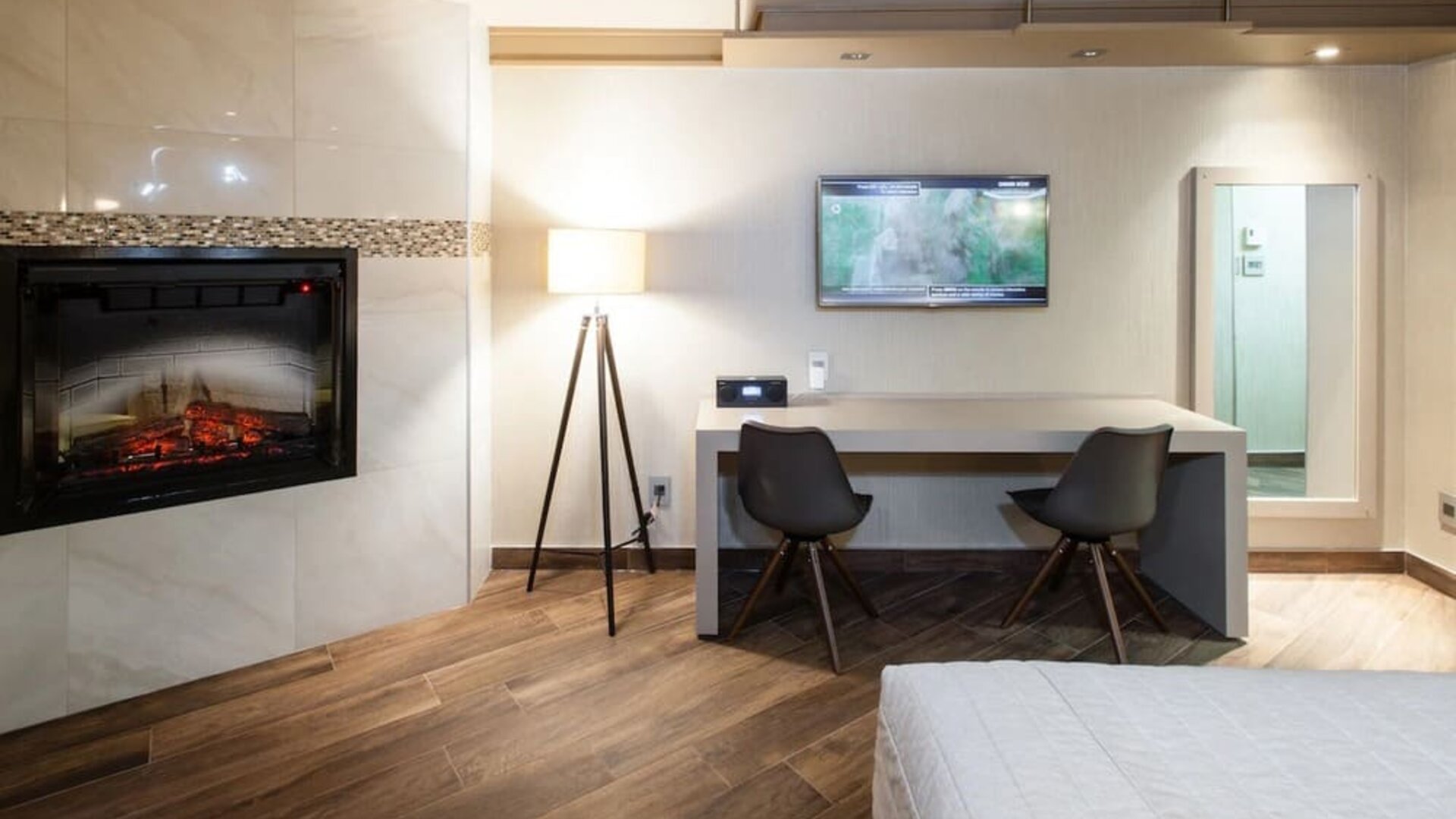 Day use room with TV, work desk, fireplace and private bathroom at Le Chabrol Hotel Et Suites.
