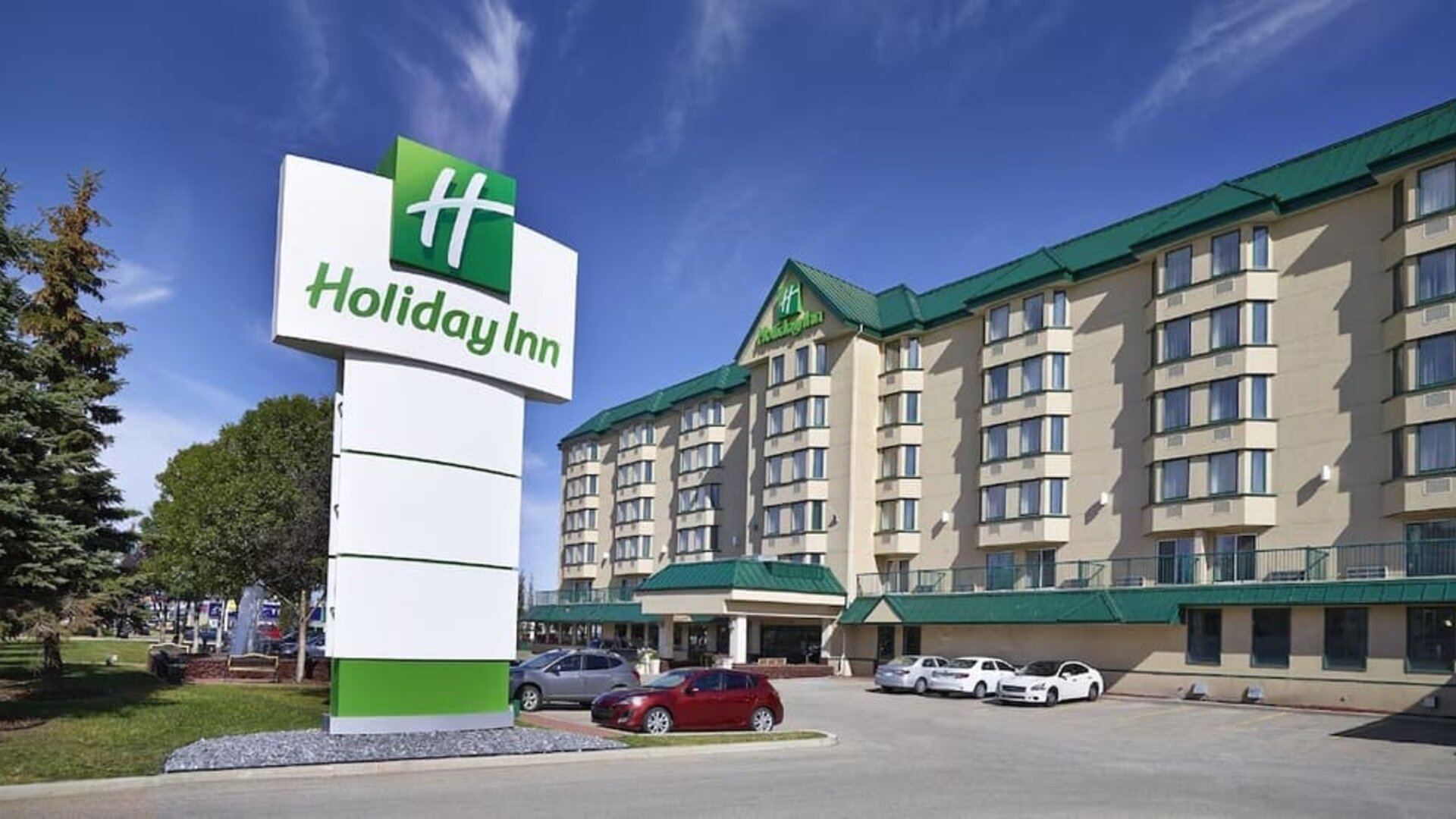 Hotel exterior and parking area at Holiday Inn Conference Center Edmonton South.
