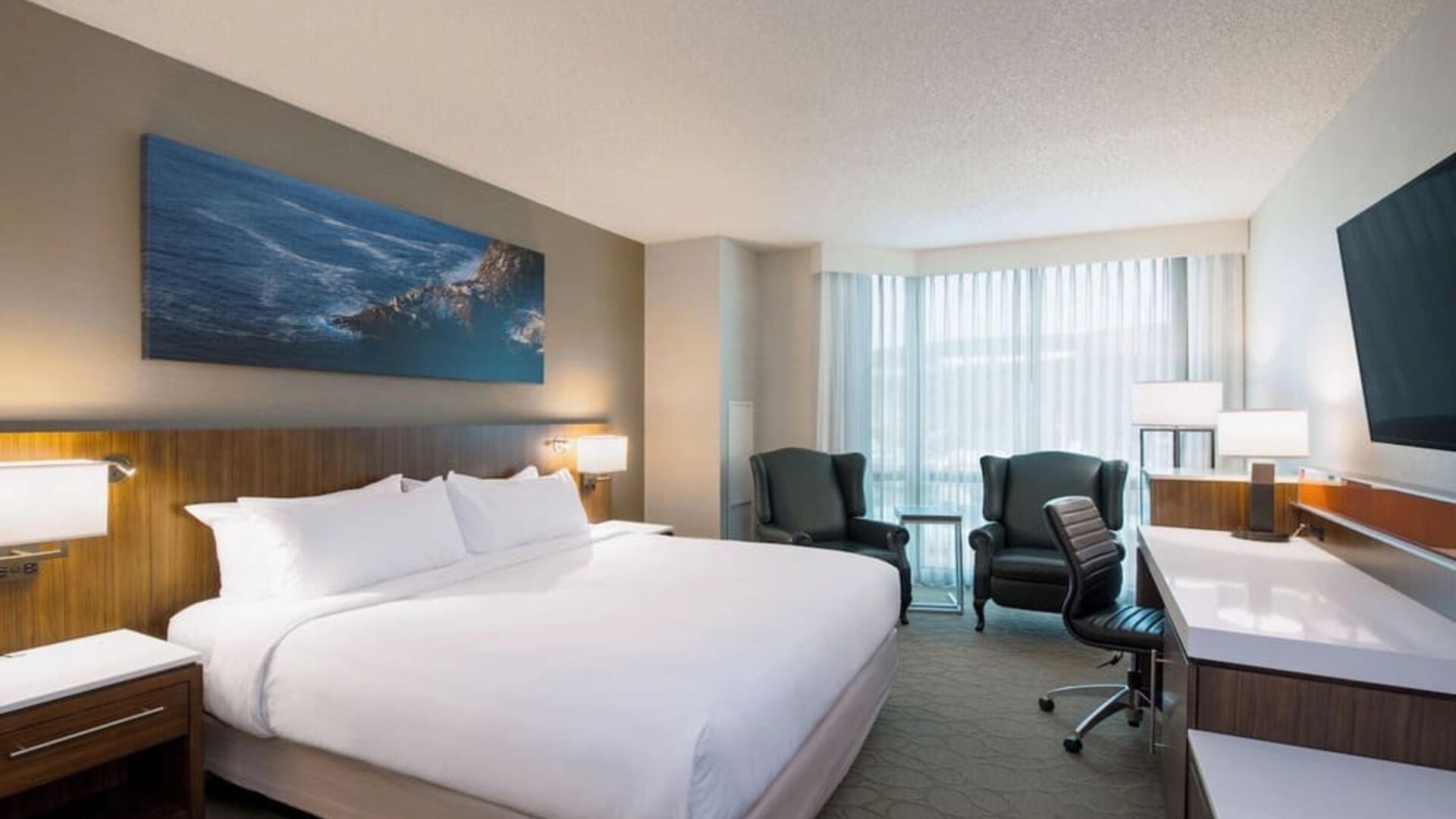 Day use room with TV, work desk and sofas at Delta St. John's Hotel & Conference Center.