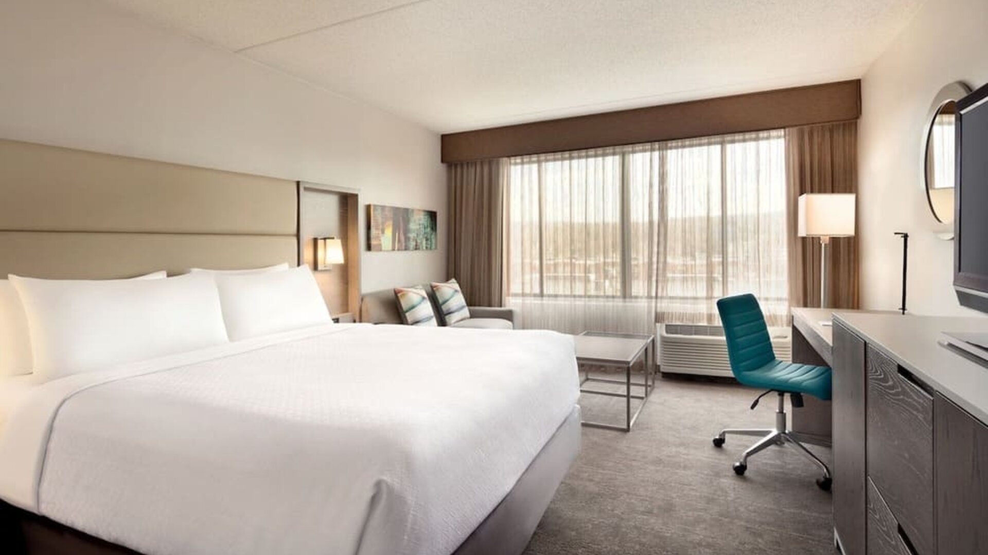 Day use room with work desk and sofa at Crowne Plaza Englewood.