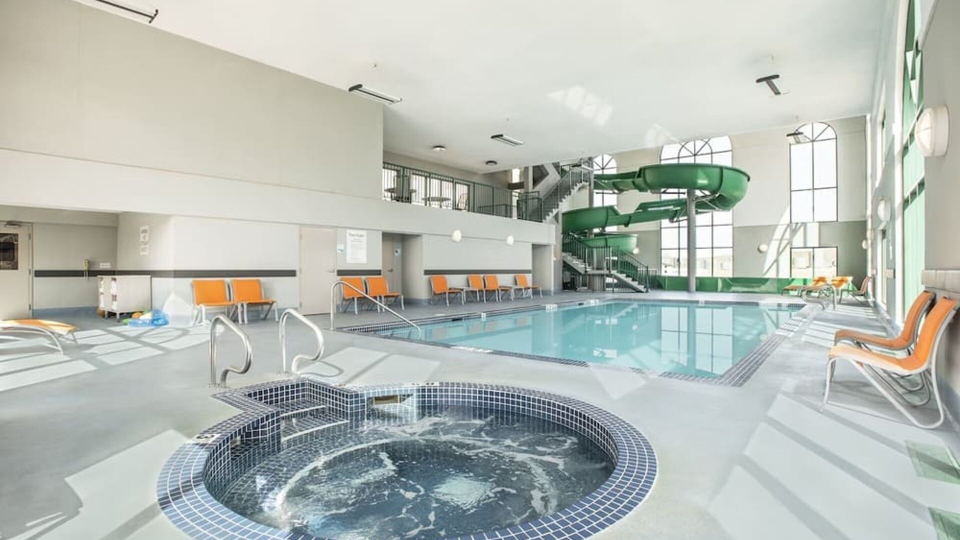 Indoor pool, jacuzzi and water slide at Holiday Inn Express & Suites Medicine Hat.