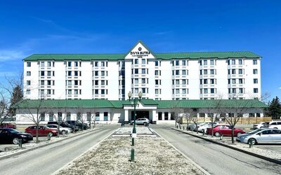 Hotel exterior and parking area at Divya Sutra Plaza & Conference Centre.