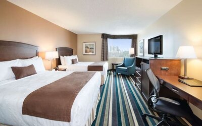 Day use twin room with work desk, TV and sofa at Best Western Plus Winnipeg Airport.