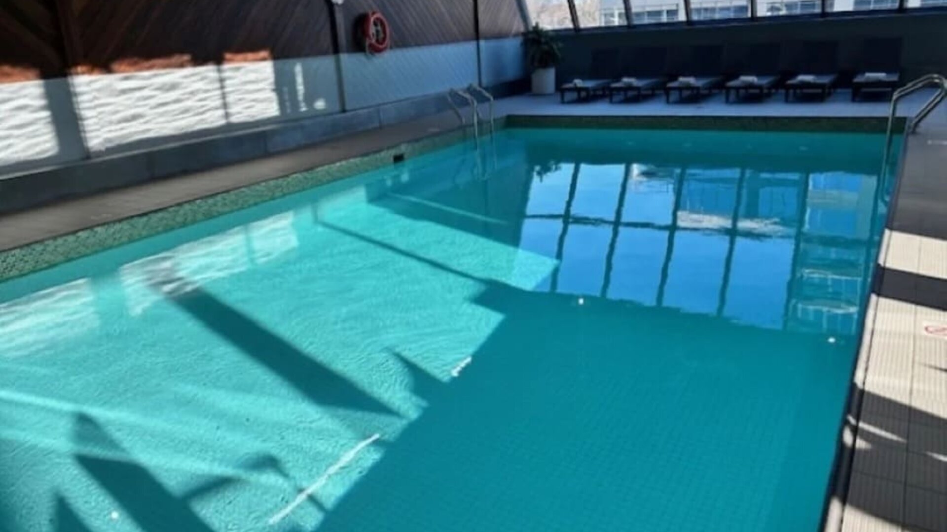 Relaxing indoor pool with lounge chairs at Atlantica Hotel Halifax.