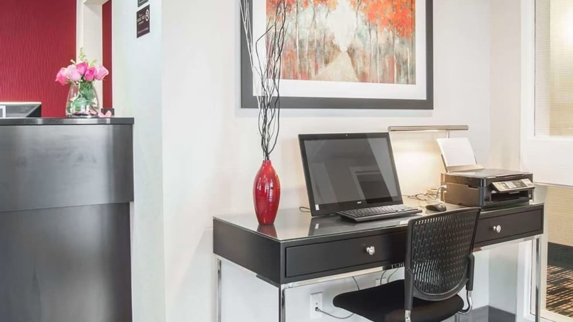 Business center with computer, printer and ergonomic chair at Comfort Inn Fredericton.