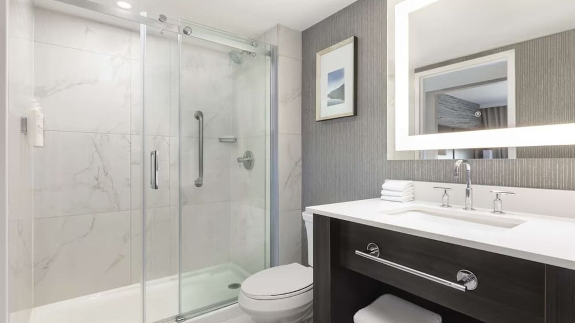 Guest bathroom with shower and free toiletries at Embassy Suites By Hilton Toronto Airport.