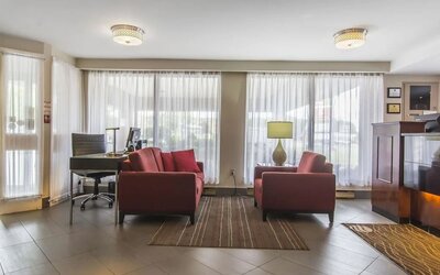 The hotel lobby has comfortable seating, and is brightly lit thanks to large windows.